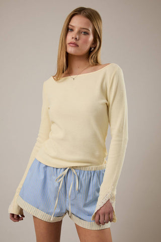 Woman wearing blue striped drawstring shorts with cuffed hem and elastic waistband.