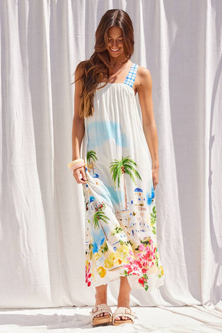Flowy maxi dress with scenic coastal print featuring palm trees, ocean, and florals with gingham straps