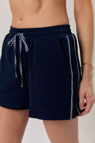 Relaxed fit lounge shorts with gingham trim detail in navy and red color options