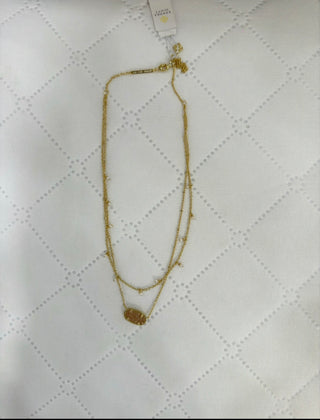 Kendra Scott Elisa Pearl Multi Strand Necklace featuring a signature Elisa pendant with layered freshwater pearl accents on a gold chain.