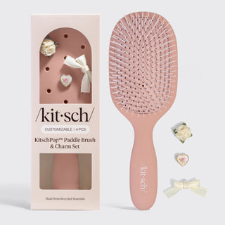 Terracotta paddle hair brush with customizable charm accents and soft feminine design.