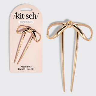 Mini gold bow French hair pin used for styling buns and elegant updos.