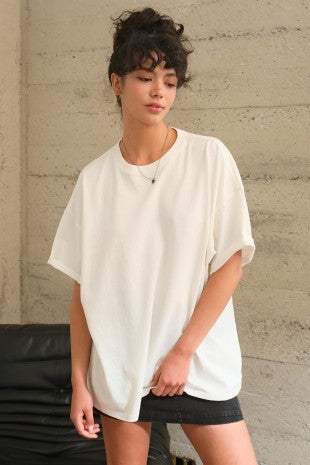 Woman wearing mineral-washed relaxed white tee with classic crew neckline.
