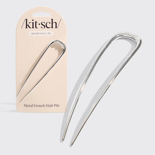 Silver metal French hair pin used for secure buns and minimalist hairstyles.